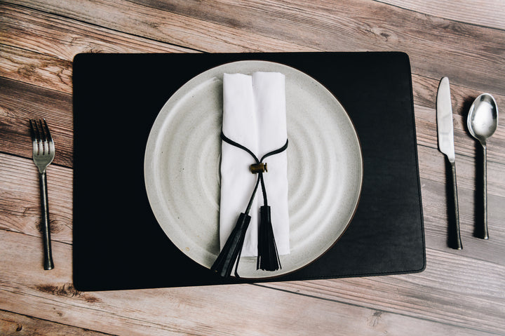 Add elegance to your dining table with the Nash leather placemat. Available in three classic, neutral colors, the Nash leather placemat is backed with a non-skid durable rubber mat. #color_black