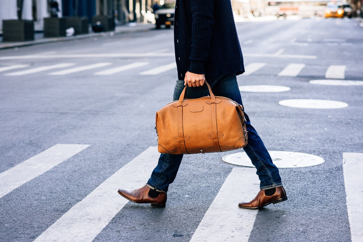Limited Edition 22” Weekender Handcrafted with long weekend getaways in mind, the limited edition Centennial Taft weekender is inspired by the rugged duffel bags made for outdoorsmen in the 1960s. It combines rugged functionality with modern design and features a durable, natural leather lining as well as a removable organizer panel that’s perfect for storing small accessories while on the go. #color_tan