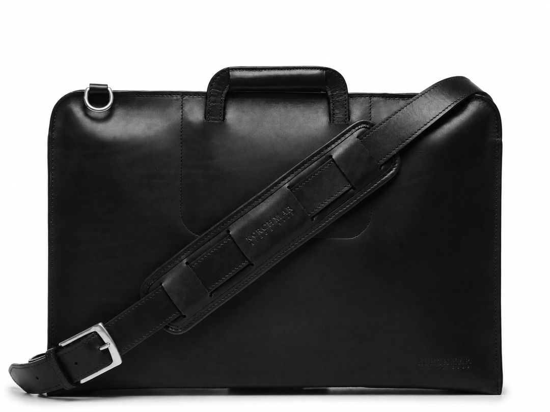 Black Leather Zippered Briefcase The Jackson is handcrafted with a beautiful full grain mill dyed American leather in a timeless Korchmar design. It includes a removable padded laptop sleeve. Historically not an item designed for shoulder carry, the new, improved design includes a full length adjustable shoulder strap. #color_black
