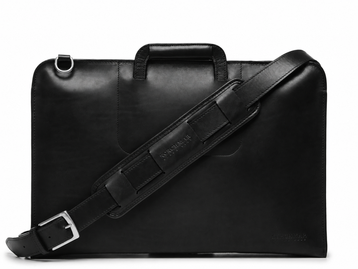Black Leather Zippered Briefcase The Jackson is handcrafted with a beautiful full grain mill dyed American leather in a timeless Korchmar design. It includes a removable padded laptop sleeve. Historically not an item designed for shoulder carry, the new, improved design includes a full length adjustable shoulder strap. #color_black