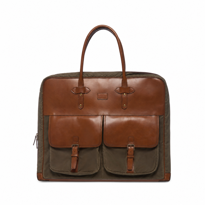 Olive Front view of the Prescott olive waxed canvas garment bag with brown leather trim and two exterior pockets