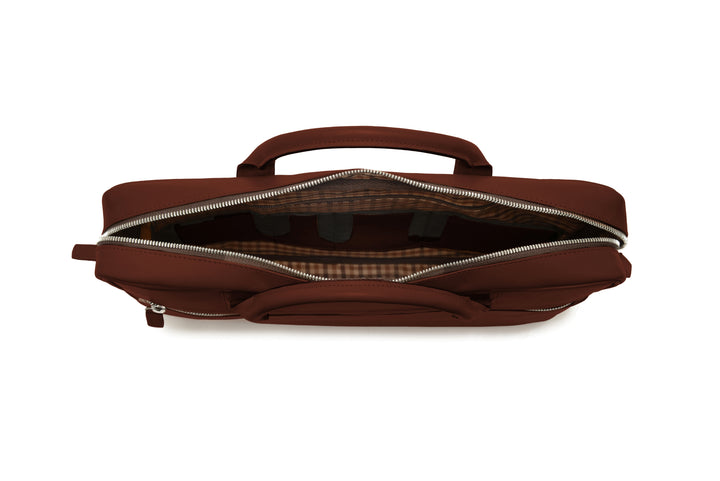 Brown Full-grain mill dyed American saddle leather Solid brass hardware in matte nickel finish Solid brass polished tooth zipper Removable, adjustable shoulder strap with ergonomic pad Front zippered and slim literature pocket on the back Removable, snap-in key chain Padded interior computer pocket Fully lined with signature 6.4 oz yarn dyed twill Carry bag strap slide over telescoping luggage handle Handcrafted with care in our own factory Fits most 15" laptops #color_brown