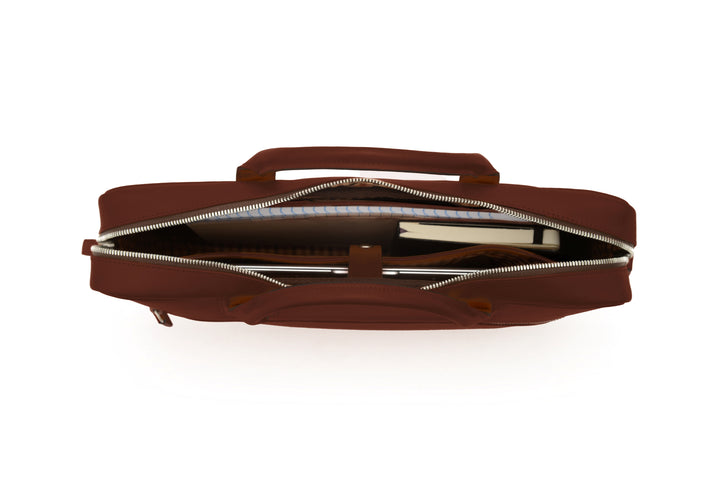 Brown Full-grain mill dyed American saddle leather Solid brass hardware in matte nickel finish Solid brass polished tooth zipper Removable, adjustable shoulder strap with ergonomic pad Front zippered and slim literature pocket on the back Removable, snap-in key chain Padded interior computer pocket Fully lined with signature 6.4 oz yarn dyed twill Carry bag strap slide over telescoping luggage handle Handcrafted with care in our own factory Fits most 15" laptops #color_brown