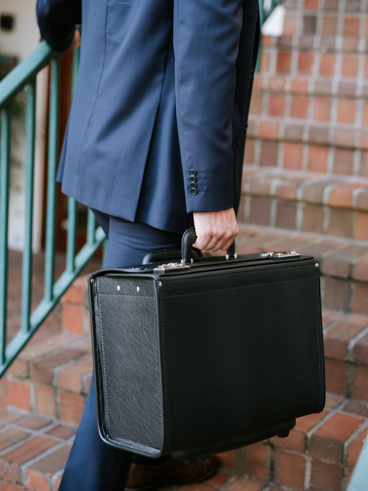 Black Vinyl Wheeled Catalog Case A top selling professional catalog case, the Defender is a durable and sleek solution for transporting a large volume of files. The Defender features a secure combination locking system, and is handcrafted using Marvelon vinyl.