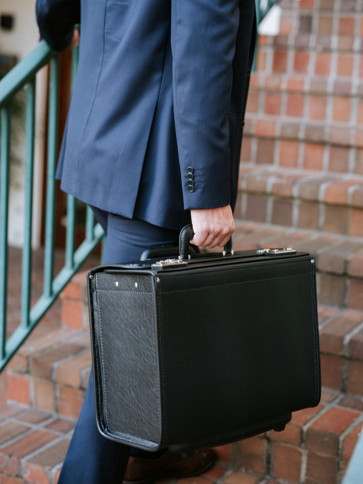 Black Vinyl Wheeled Catalog Case A top selling professional catalog case, the Defender is a durable and sleek solution for transporting a large volume of files. The Defender features a secure combination locking system, and is handcrafted using Marvelon vinyl.