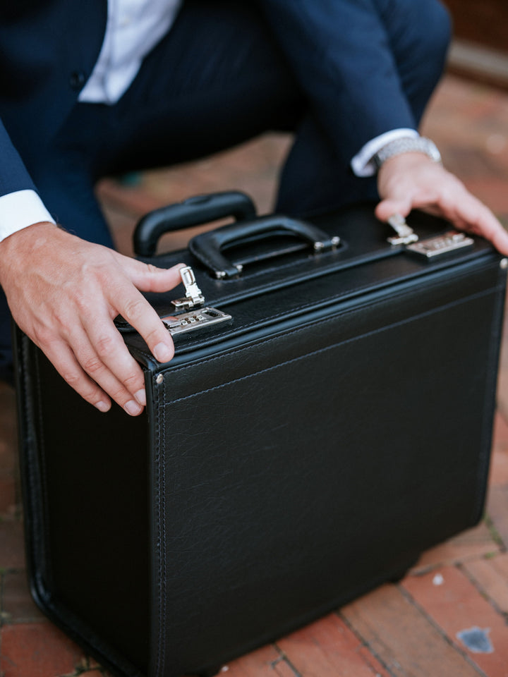 Black Vinyl Wheeled Catalog Case A top selling professional catalog case, the Defender is a durable and sleek solution for transporting a large volume of files. The Defender features a secure combination locking system, and is handcrafted using Marvelon vinyl.