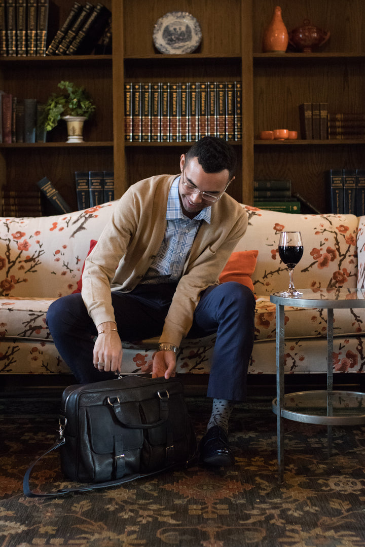 Full grain American pebbled leather trimmed with oil tanned saddle leather Spacious interior single gusset Built-in 15" laptop sleeve Zippered interior pocket Multiple expandable leather organizer pockets #color_blue