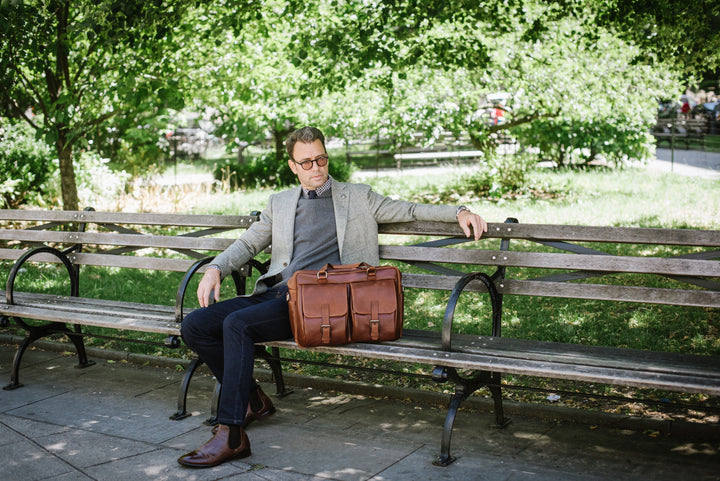 Full grain American pebbled leather trimmed with oil tanned saddle leather Spacious interior single gusset Built-in 15" laptop sleeve Zippered interior pocket Multiple expandable leather organizer pockets #color_chocolate