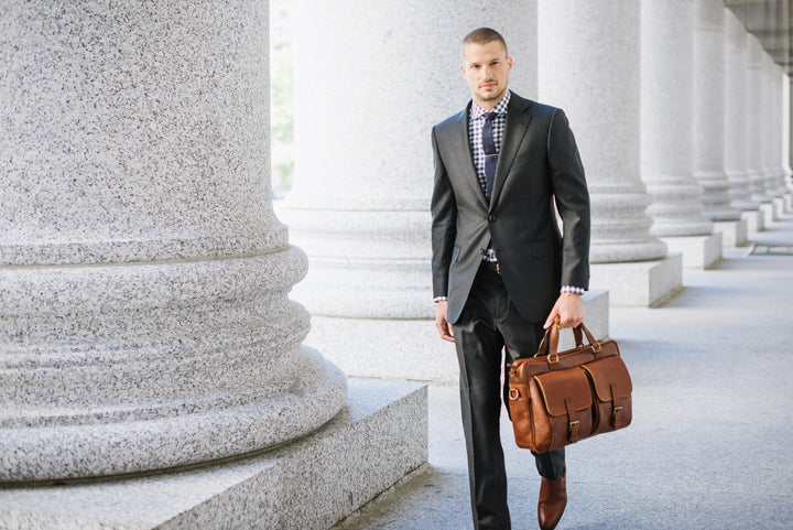 Full grain American pebbled leather trimmed with oil tanned saddle leather Spacious interior single gusset Built-in 15" laptop sleeve Zippered interior pocket Multiple expandable leather organizer pockets #color_chocolate