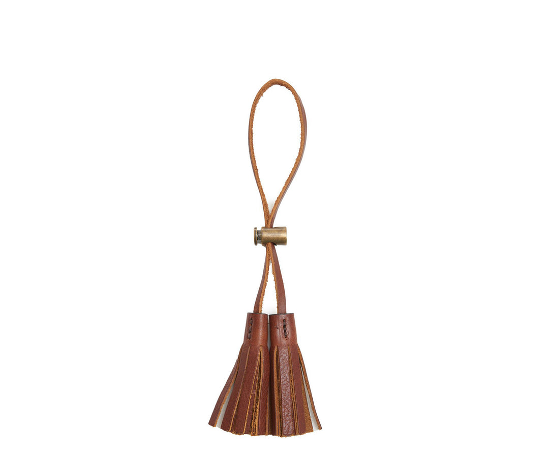 Chocolate Leather tassel keeper Add texture to your décor and get creative with the Cooper leather tassel keepers. Perfect for use as napkin holders, on curtains or doorknobs, as carry-on bag identifiers, and so much more. The Cooper leather tassel keepers are handcrafted with full-grain American leather. #color_chocolate
