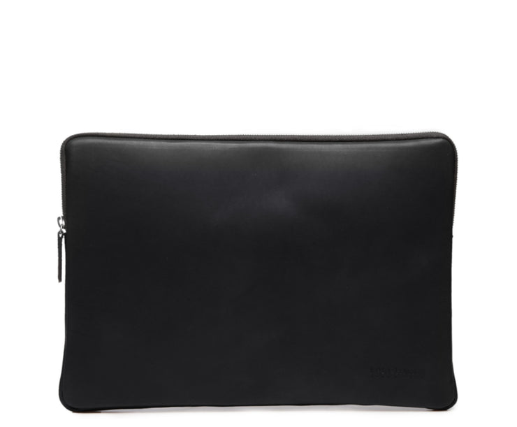 Black Laptop Sleeve The Clifford laptop sleeve in Korchmar's Classic Leather is made of American cowhide leather that is selected from the top 5% of available hides. Colored only with aniline dyes, this leather retains its natural beauty over time and features visible markings that are characteristic of only the finest leather.