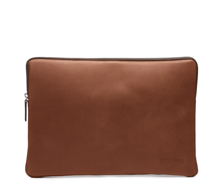 Brown Laptop Sleeve The Clifford laptop sleeve in Korchmar's Classic Leather is made of American cowhide leather that is selected from the top 5% of available hides. Colored only with aniline dyes, this leather retains its natural beauty over time and features visible markings that are characteristic of only the finest leather. #color_brown