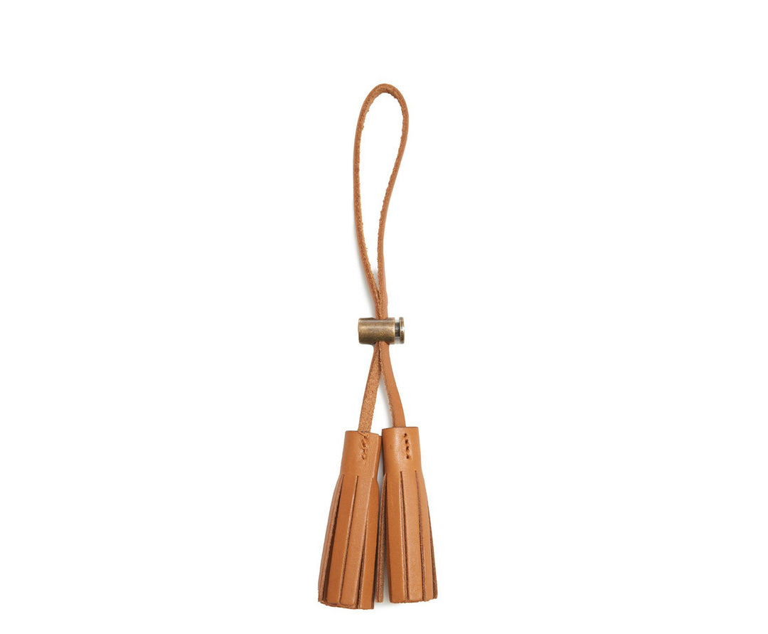 Tan Leather tassel keeper Add texture to your décor and get creative with the Cooper leather tassel keepers. Perfect for use as napkin holders, on curtains or doorknobs, as carry-on bag identifiers, and so much more. The Cooper leather tassel keepers are handcrafted with full-grain American leather. #color_tan