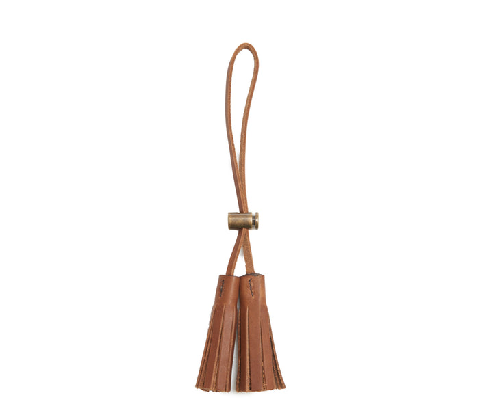 Espresso Leather tassel keeper Add texture to your décor and get creative with the Cooper leather tassel keepers. Perfect for use as napkin holders, on curtains or doorknobs, as carry-on bag identifiers, and so much more. The Cooper leather tassel keepers are handcrafted with full-grain American leather. #color_espresso