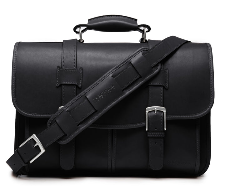 Black Exterior back pocket and zipped interior pocket Pillow soft padded leather handle Removable, adjustable shoulder strap with ergonomic pad Carry bag strap to slide over telescoping luggage handle Protective laptop compartment Handcrafted with care in our own factory Fits up to a 15" laptop Dimensions: 16.5" x 6" x 13" #color_black