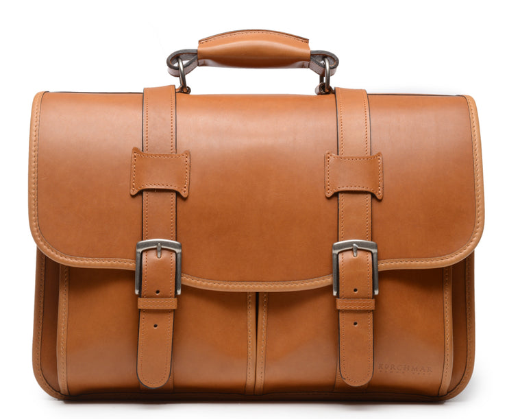 Tan Leather Laptop Briefcase The Garfield business briefcase in Korchmar's Classic Leather is made of American cowhide leather that is selected from the top 5% of available hides. Colored only with aniline dyes, this leather retains its natural beauty over time and features visible markings that are characteristic of only the finest leather. 