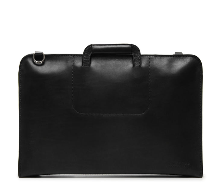 Black Full grain mill dyed American leather exterior and interior Telescoping handles allow for easy access to interior easy underarm carry Cell phone, tablet, pen and notebook pockets Solid Brass hardware in matte nickel finish Full length solid brass polished tooth zipper allowing lay flat use Adjustable, removable shoulder strap Handcrafted in our own factory Removable, padded computer sleeve designed for most 15" laptops Dimensions: 17" x 3" x 11.5"