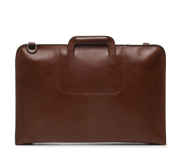 Brown Full grain mill dyed American leather exterior and interior Telescoping handles allow for easy access to interior easy underarm carry Cell phone, tablet, pen and notebook pockets Solid Brass hardware in matte nickel finish Full length solid brass polished tooth zipper allowing lay flat use Adjustable, removable shoulder strap Handcrafted in our own factory Removable, padded computer sleeve designed for most 15" laptops Dimensions: 17" x 3" x 11.5"
