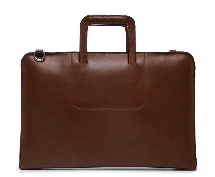 Brown Leather Zippered Briefcase The Jackson is handcrafted with a beautiful full grain mill dyed American leather in a timeless Korchmar design. It includes a removable padded laptop sleeve. Historically not an item designed for shoulder carry, the new, improved design includes a full length adjustable shoulder strap.