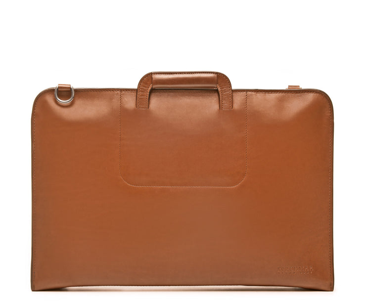 Tan Full grain mill dyed American leather exterior and interior Telescoping handles allow for easy access to interior easy underarm carry Cell phone, tablet, pen and notebook pockets Solid Brass hardware in matte nickel finish Full length solid brass polished tooth zipper allowing lay flat use Adjustable, removable shoulder strap Handcrafted in our own factory Removable, padded computer sleeve designed for most 15" laptops Dimensions: 17" x 3" x 11.5"