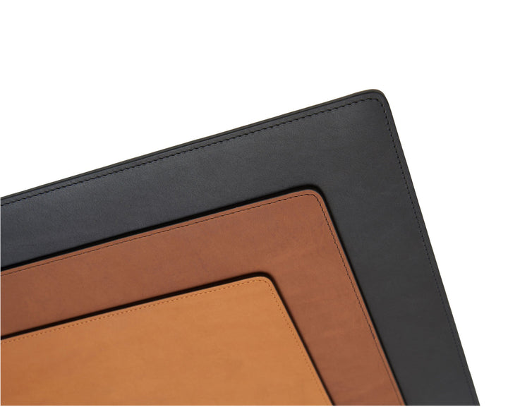 Black Full-grain American leather Backed with non-skid durable rubber mat Each placemat's selection is one-of-a-kind and slightly unique given the natural characteristics of the leather Handcrafted with care in our own factory Dimensions: 18" W x 12" H #color_black