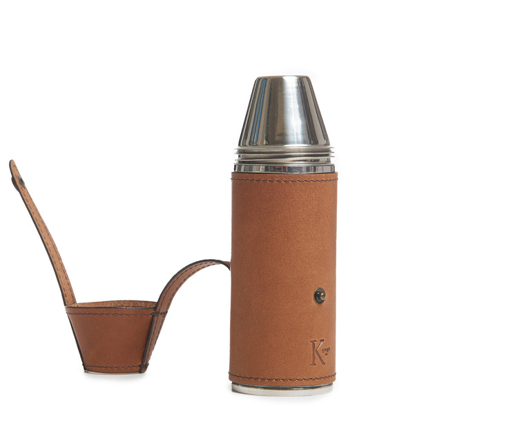 Espresso Full-grain American leather Includes stainless steel flask funnel and four stainless steel serving cups 8 oz capacity Handcrafted with care in our own factory Dimensions: 6.5" H x 2" D