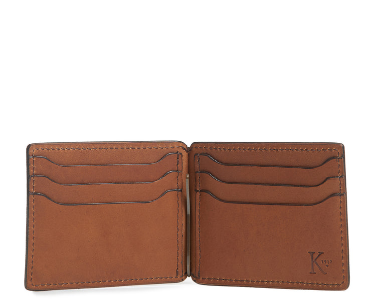 Espresso Handcrafted with American full-grain vegetable tanned leather One full length bill pocket with leather lined back 6 credit card slots with scalloped shape for easy card recognition 2 vertical stash pockets All edges are hand burnished and inked Dimensions: 3.25" x .5" x 4.5"