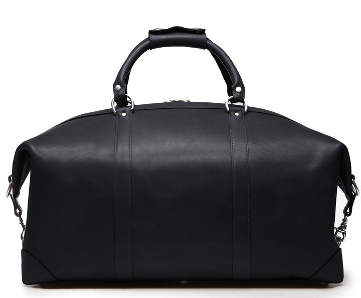 Black Full grain American leather finished with natural oils and waxes Solid nickel antiqued hardware Clamp down ends allow for expansion and increased interior capacity Fully lined with signature 6.4 oz yarn dyed twill Interior zippered pockets Removable, adjustable shoulder strap with ergonomic pad Customizable monogram patch on exterior Handcrafted with care in our own factory Dimensions: 22" x 10" x 14" #color_black