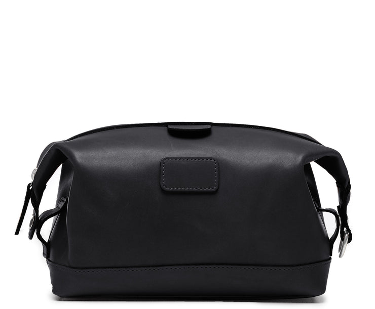 Black Leather Dopp Kit The Ryder dopp kit in Korchmar's Classic Leather is made of American cowhide leather that is selected from the top 5% of available hides. Colored only with aniline dyes, this leather retains its natural beauty over time and features visible markings that are characteristic of only the finest leather. The Ryder features a top zipper and snap down ends that allow for maximum expansion.