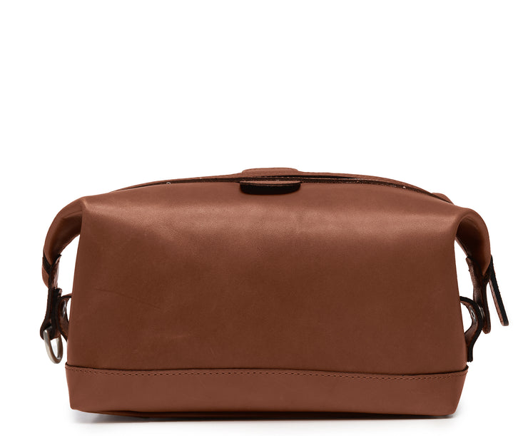 Brown Full grain American leather Antique nickel hardware Snap down ends, which allow for expansion Fully lined with signature 6.4 oz yarn dyed twill Zipper length of 13.25" Handcrafted with care in our own factory Dimensions: 11" x 5" x 6"