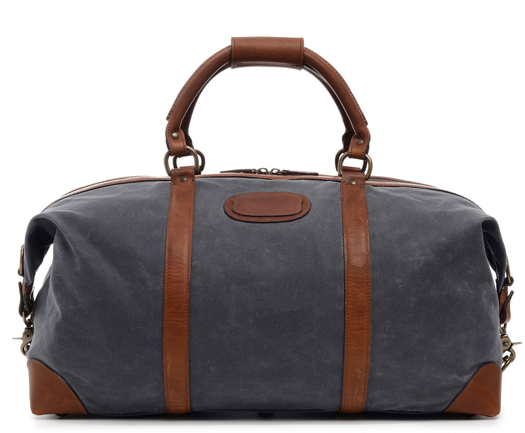 Grey 22" Waxed Canvas Weekender One of our best-selling weekender styles, the waxed canvas Twain is ideal for leisure or business travel. At 22", it is designed to fit comfortably in most airline overhead compartments. The Twain waxed canvas duffel bag is handcrafted with water-resistant waxed canvas and includes a removable, adjustable leather shoulder strap. #color_grey