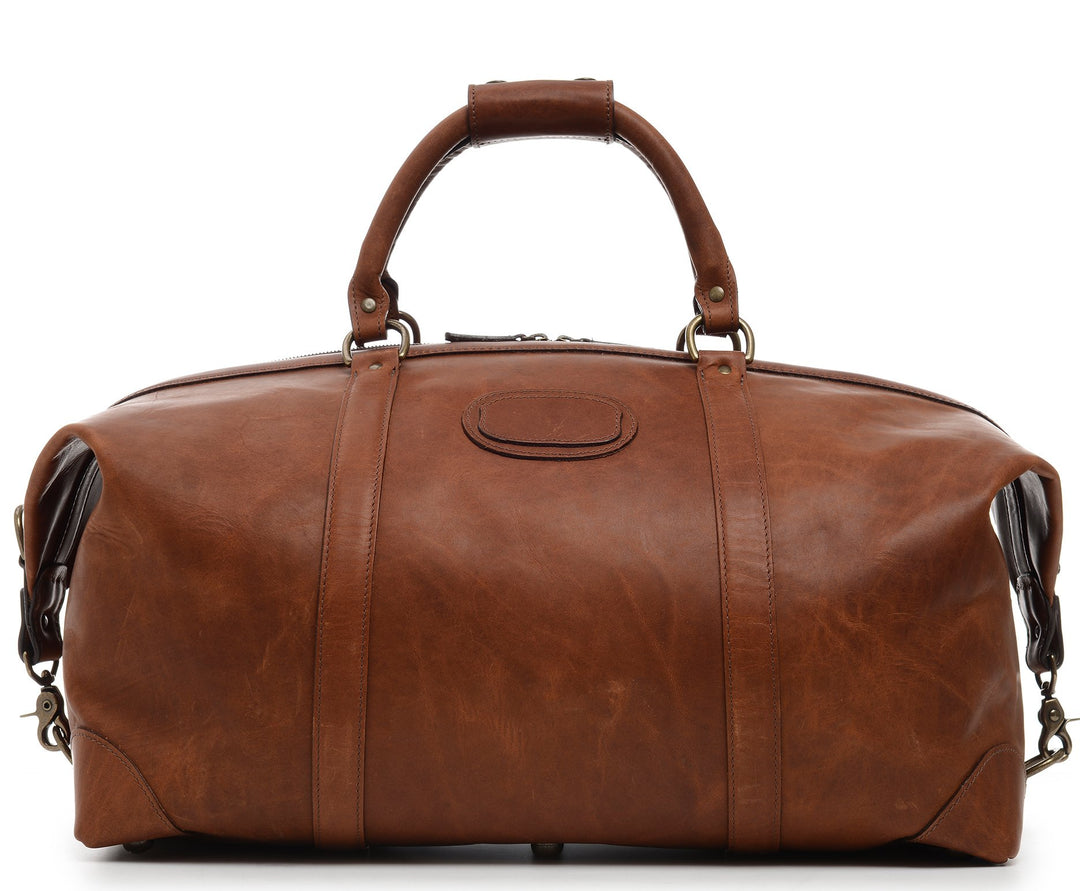 Espresso 22" Leather Weekender One of our best-selling weekender styles, the Twain is ideal for leisure or business travel. At 22", it is designed to fit comfortably in most airline overhead compartments. The Twain leather duffel bag is handcrafted in the USA with full grain leather that develops a beautiful patina with time. It includes a removable, adjustable shoulder strap.