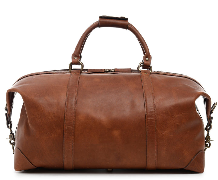 Espresso One of our best-selling weekender styles, the Twain is ideal for leisure or business travel. At 22", it is designed to fit comfortably in most airline overhead compartments. The Twain leather duffel bag is handcrafted in the USA with full grain leather that develops a beautiful patina with time. It includes a removable, adjustable shoulder strap. #color_espresso