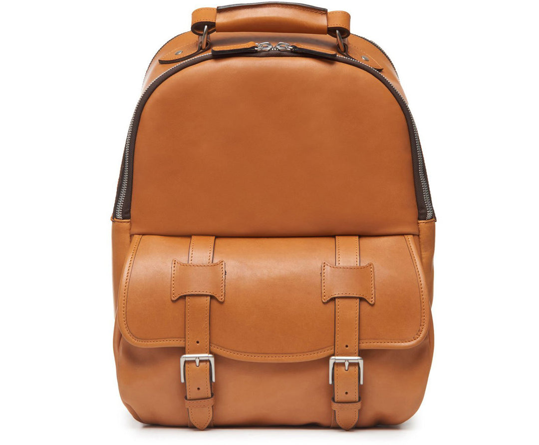 Tan Classic Leather Backpack The Lewis in Korchmar's Classic Leather is made of American cowhide leather that is selected from the top 5% of available hides. Colored only with aniline dyes, this leather retains its natural beauty over time and features visible markings that are characteristic of only the finest leather. A classic backpack silhouette, the Lewis is designed with both daily commutes and weekend excursions in mind. #color_tan
