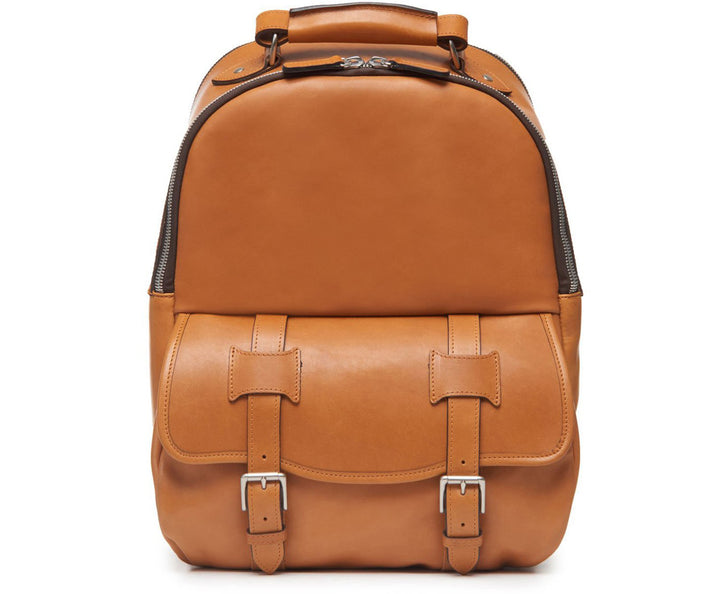 Tan Classic Leather Backpack The Lewis in Korchmar's Classic Leather is made of American cowhide leather that is selected from the top 5% of available hides. Colored only with aniline dyes, this leather retains its natural beauty over time and features visible markings that are characteristic of only the finest leather. A classic backpack silhouette, the Lewis is designed with both daily commutes and weekend excursions in mind. #color_tan