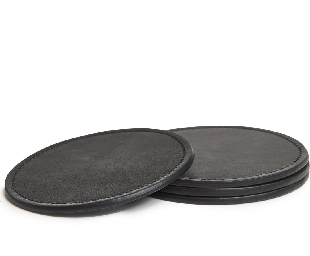 Black Hover The Walton is a 4-piece full grain leather coaster set. Designed with a simple, modern silhouette, each coaster is 4" in diameter #color_black