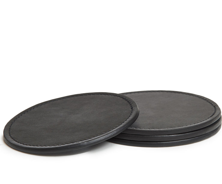 Black Hover The Walton is a 4-piece full grain leather coaster set. Designed with a simple, modern silhouette, each coaster is 4" in diameter