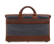 Grey Waxed canvas exterior with full grain American leather trim Single interior compartment with iPad sleeve and multiple pockets for small personal items Exterior back literature pocket and front zip pocket Solid brass hardware in antiqued finish Includes strap key hook Removable, adjustable shoulder strap with ergonomic pad Handcrafted with care in our own factory Fully lined with signature 6.4 oz yarn dyed twill Dimensions: 18" x 4.5" x 12"