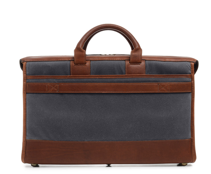 Grey Waxed canvas exterior with full grain American leather trim Single interior compartment with iPad sleeve and multiple pockets for small personal items Exterior back literature pocket and front zip pocket Solid brass hardware in antiqued finish Includes strap key hook Removable, adjustable shoulder strap with ergonomic pad Handcrafted with care in our own factory Fully lined with signature 6.4 oz yarn dyed twill Dimensions: 18" x 4.5" x 12"