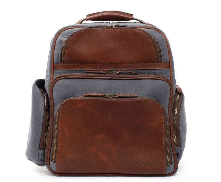 Grey Waxed Canvas and Leather Backpack The Mason is a waxed canvas and leather backpack designed to accommodate a 15" laptop. Featuring numerous organizational pockets, including a water resistant side pocket designed for water bottles, and an interior iPad pocket, the Mason is an ideal solution for work or leisure.