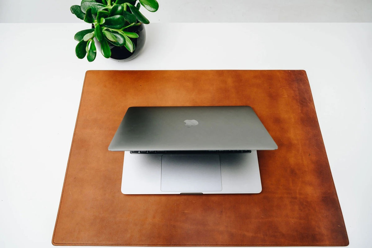 Handcrafted with American full-grain leather, the Carter leather desk pad adds a sophisticated touch to your work-from-home setup while protecting your desk's surface from scratches.