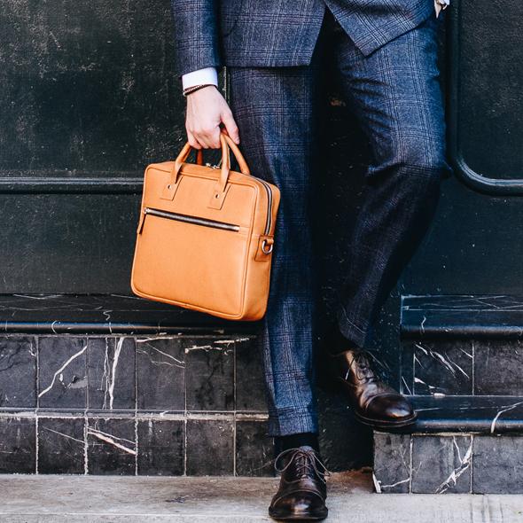 The Edwin leather briefcase features a removable, adjustable shoulder strap and built-in laptop sleeve. It is designed with a secure top zipper, and can safely accommodate most 13" laptops.