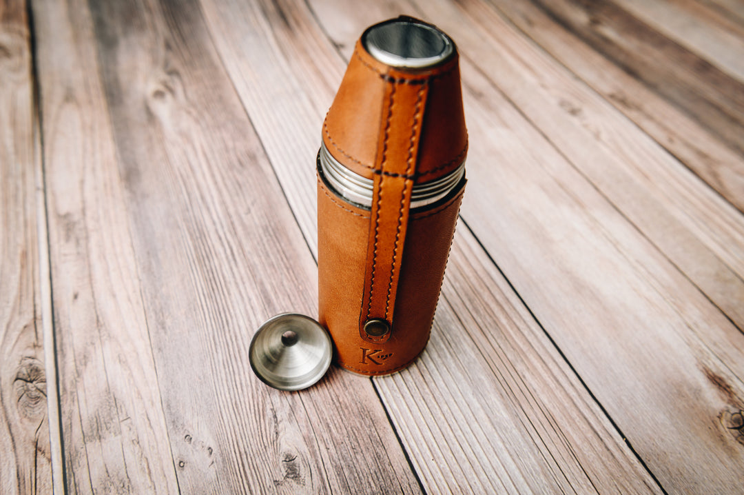 Crafted with sturdy stainless steel and wrapped in American full-grain leather, the Radcliff leather bottle flask oozes style and convenience. The Radcliff leather bottle flask includes 4 stainless steel serving cups as well as a stainless steel flask funnel for easy filling.