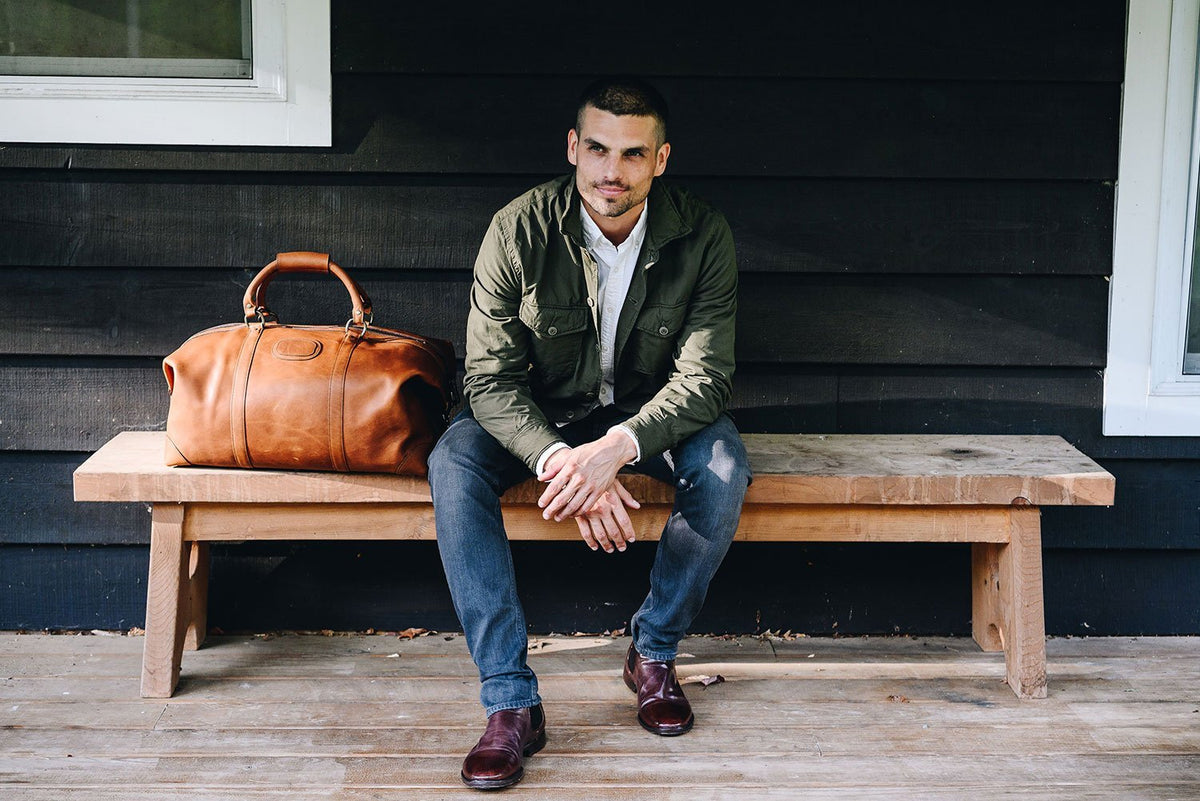 One of our best-selling weekender styles, the Twain is ideal for leisure or business travel. At 22", it is designed to fit comfortably in most airline overhead compartments. The Twain leather duffel bag is handcrafted in the USA with full grain leather that develops a beautiful patina with time. It includes a removable, adjustable shoulder strap.