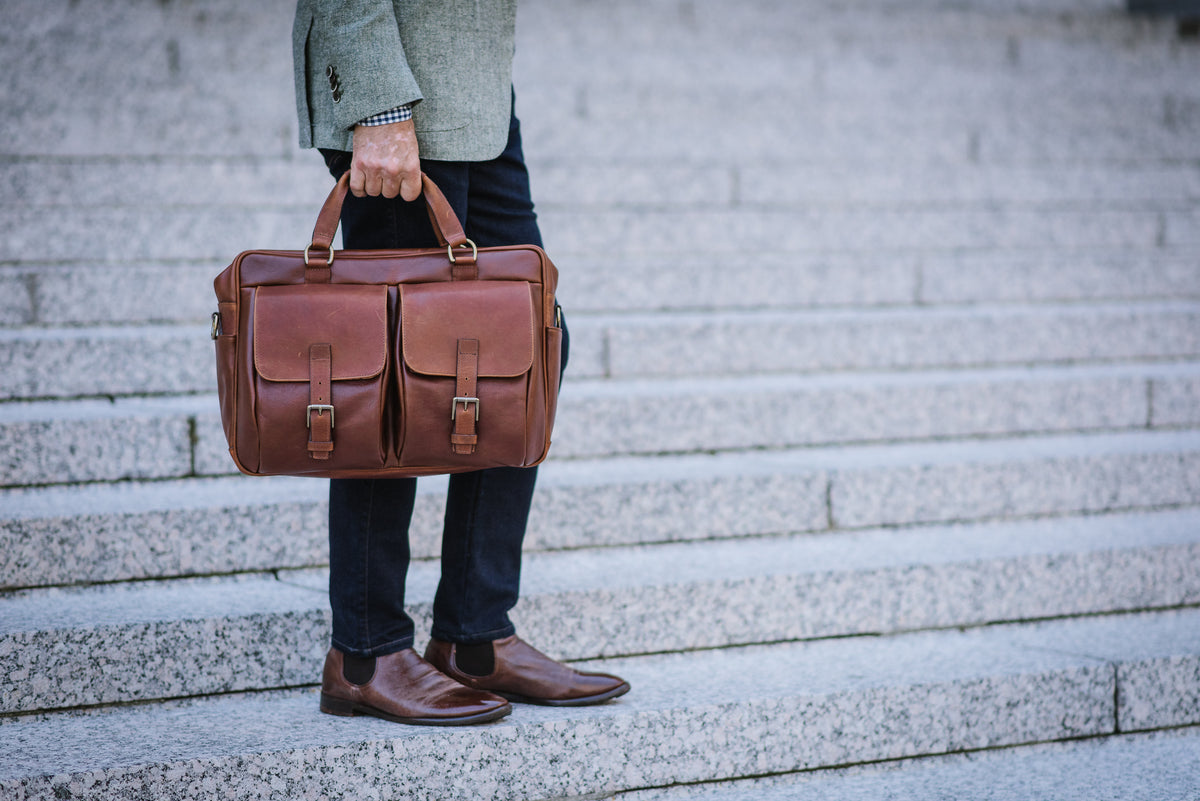 Handcrafted with full grain milled pebble grain leather, and trimmed with oil-tanned saddle leather, the Barton is a streamlined professional briefcase that features two generous front pockets, and that is designed to accommodate most 15" laptops.