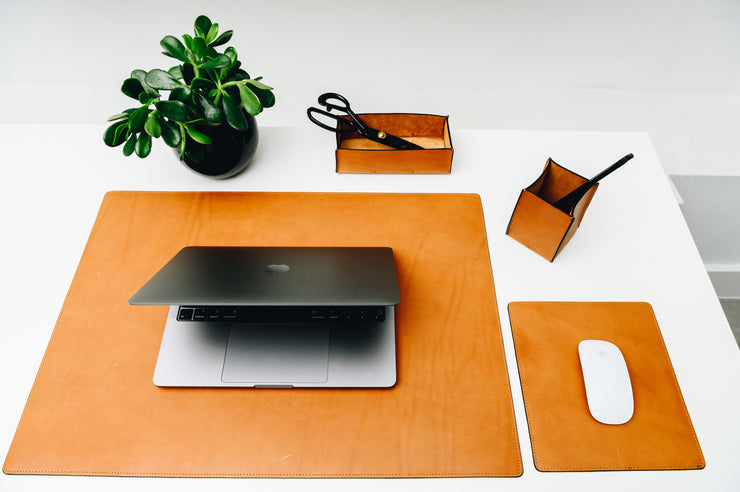 Tan Full-grain American leather Includes a desk pad, mouse pad, desk tray and pencil cup Handcrafted with care in our own factory