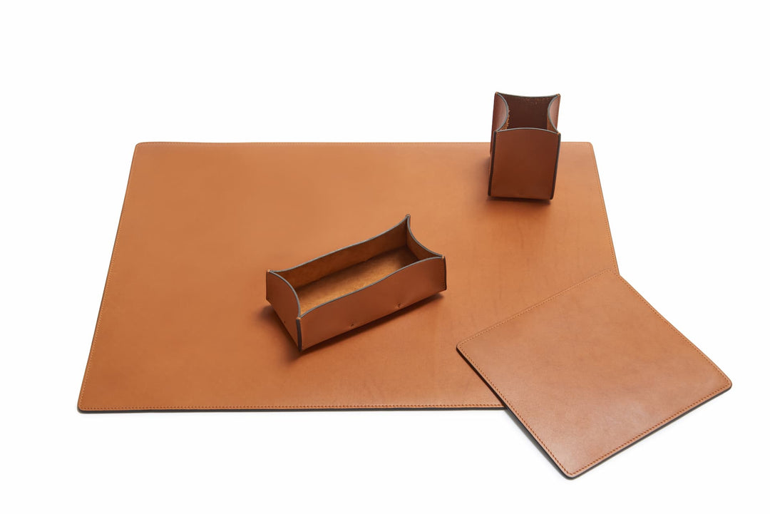 Tan Leather desk set Take your work-from-home setup to new heights with our full-grain leather desk set. Featuring our handcrafted desk pad, mouse pad, pencil tray and pencil cup, this handsome set will help keep your workspace refined and organized. #color_tan